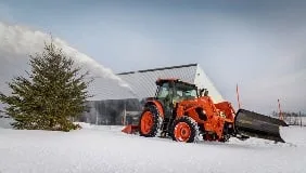 Rear snow blower working behind a Kubota tractor