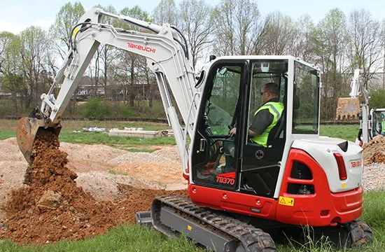 Takeuchi TB370 compact excavator working on a jobsite