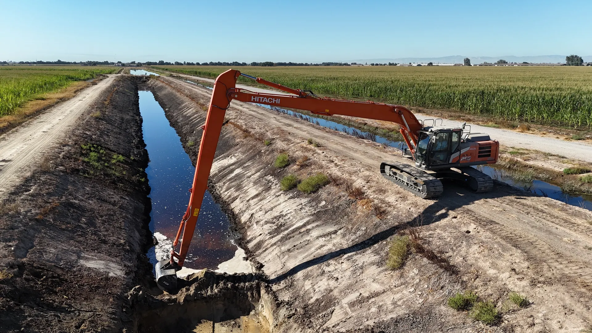 Hitachi long-reach excavator maintaining a California canal