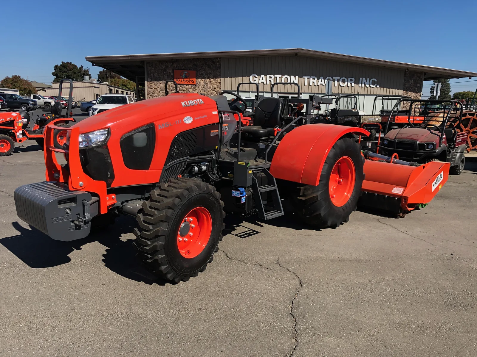 Kubota M Series tractor in front of a Garton Tractor store